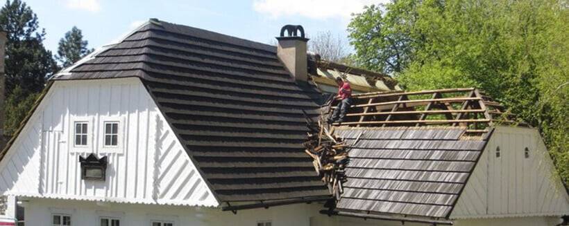 worker working on roof on a heritage home