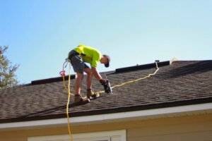 Roofing Maintenance worker on a rooftop - commercial roofing in 2023
