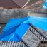 blue tarps on damage residential roofs in need of repair