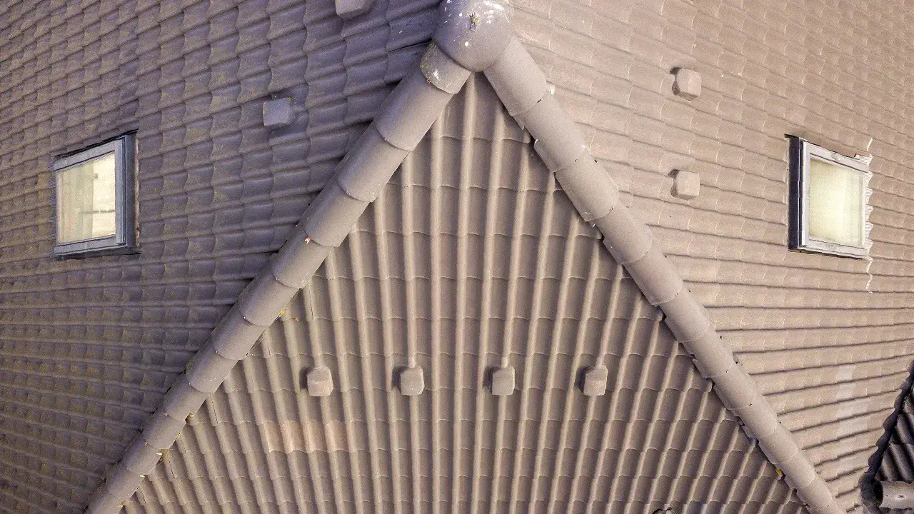A top-down view of roof shingles highlights the importance of residential roof venting for optimal airflow
